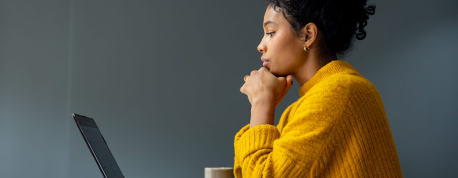 Review your Employee Value Proposition - businesswoman working on her laptop at the office and staring at her screen