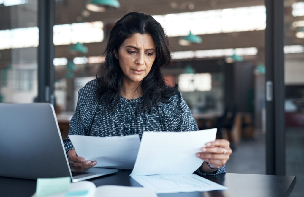 Talent Acquisition Strategies During Economic Downturns. Woman working at a desk.