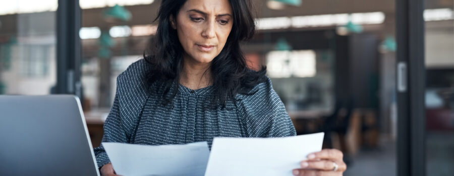 Talent Acquisition Strategies During Economic Downturns. Woman working at a desk.