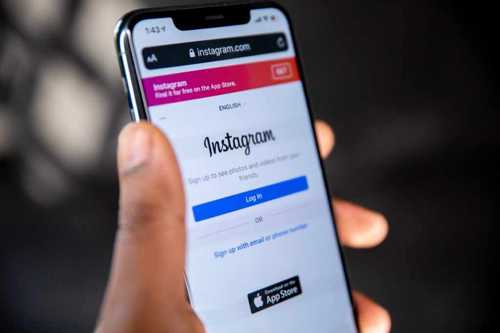 A person holding a phone browsing the Instagram website